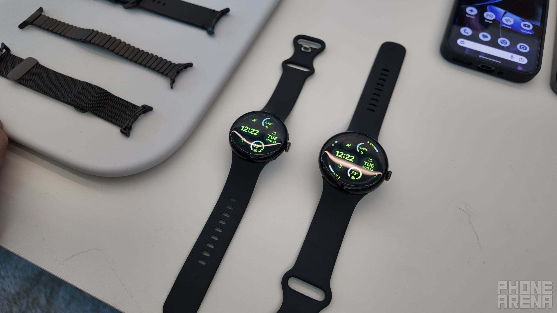 Pixel Watch 3 in black color displayed on a table, showcasing two different sizes side by side.