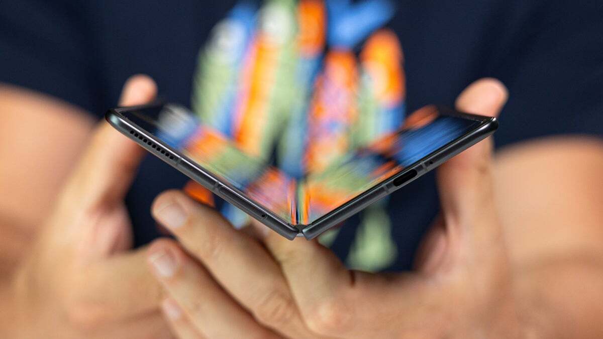 A close-up of a man holding the Honor Magic V3.