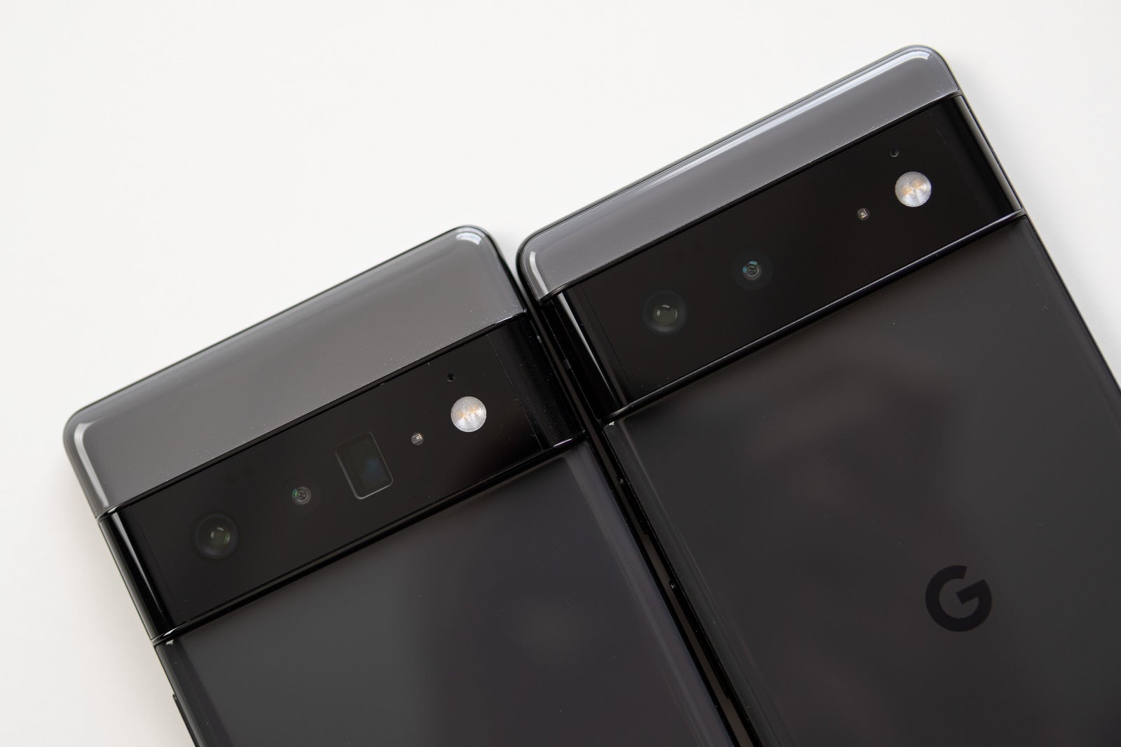 An image of the backs of a Google Pixel 6 and 6 Pro laid down side by side