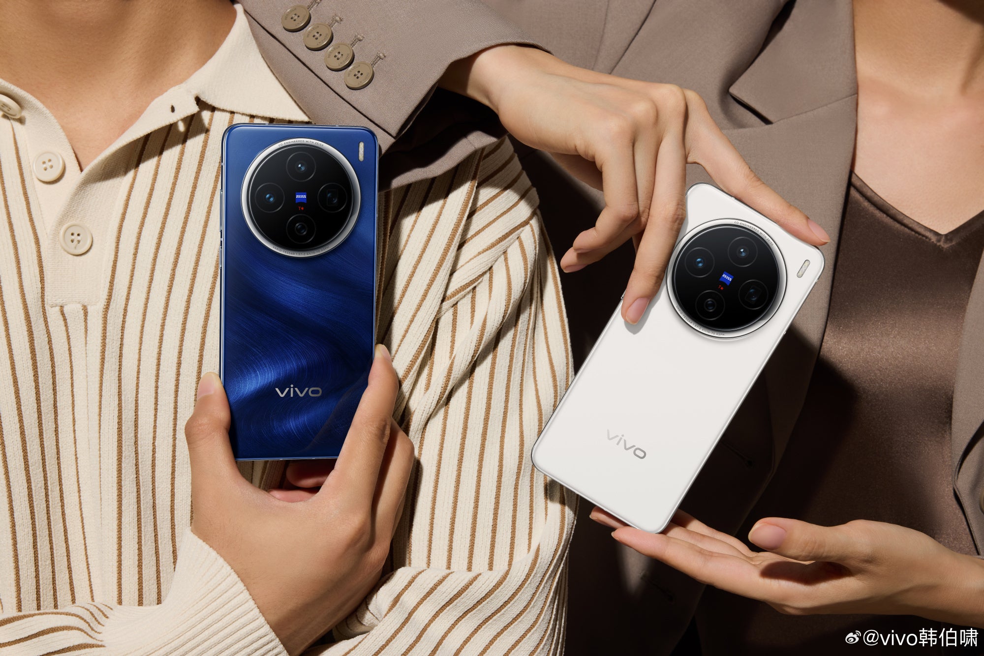 Two individuals holding vivo X200 smartphones, one in dark blue and the other in white.