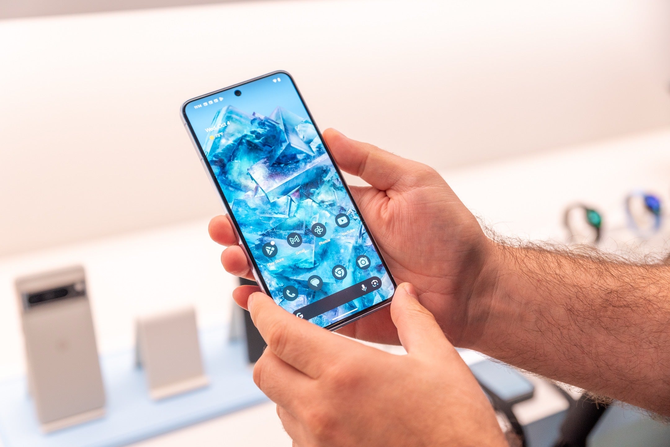 Image of a person's hand holding up a Google Pixel 8 Pro