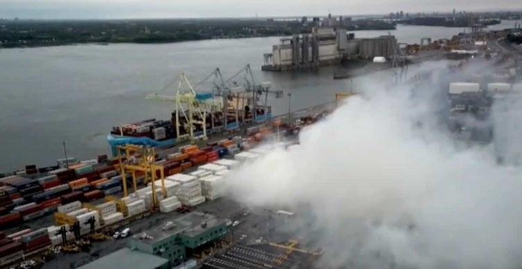 Smoke is visible from the fire, which started in a container containing a 15,000 kilowatt lithium-ion battery.