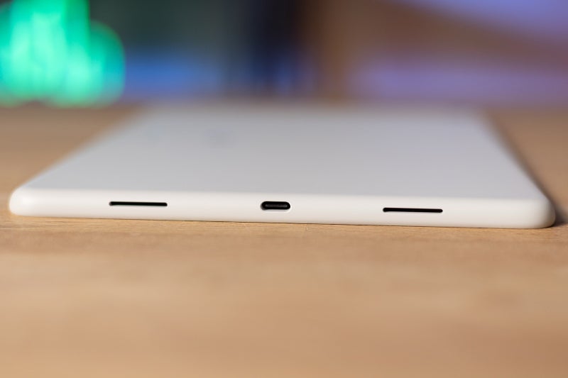 An image of the Google Pixel tablet sitting face down on a table exposing its usb-c port