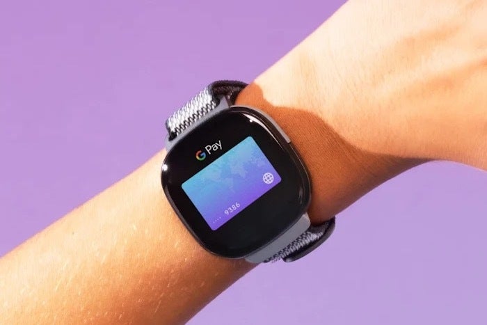 An image of a child&amp;#039;s arm wearing a Fitbit device with Google Wallet