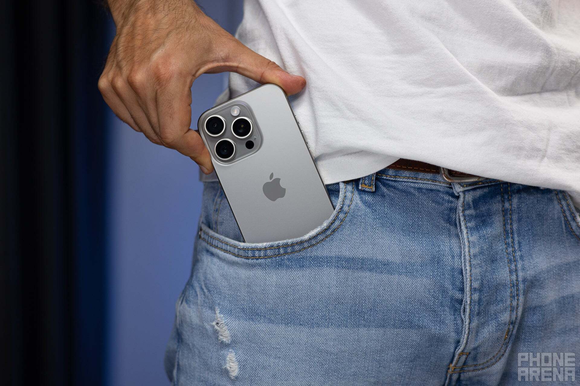 An iPone 16 Pro Max being taken out of a person&#039;s jean pocket.