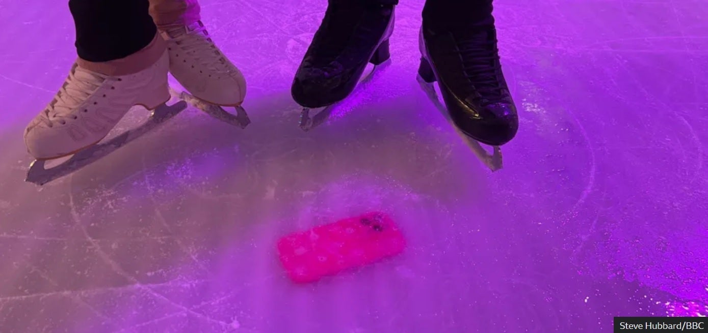 An iPhone is frozen under the ice of a U.K. skating rink and will remain there until the rink is taken down in January. | Image credit-BBC - iPhone is entombed in a skating rink until January