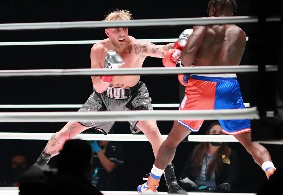 Jake Paul, at left, in action during a 2020 fight. | Image credit-Handout Photo - Despite streaming issues, Netflix set a U.S. viewership record during Friday night&#039;s bout