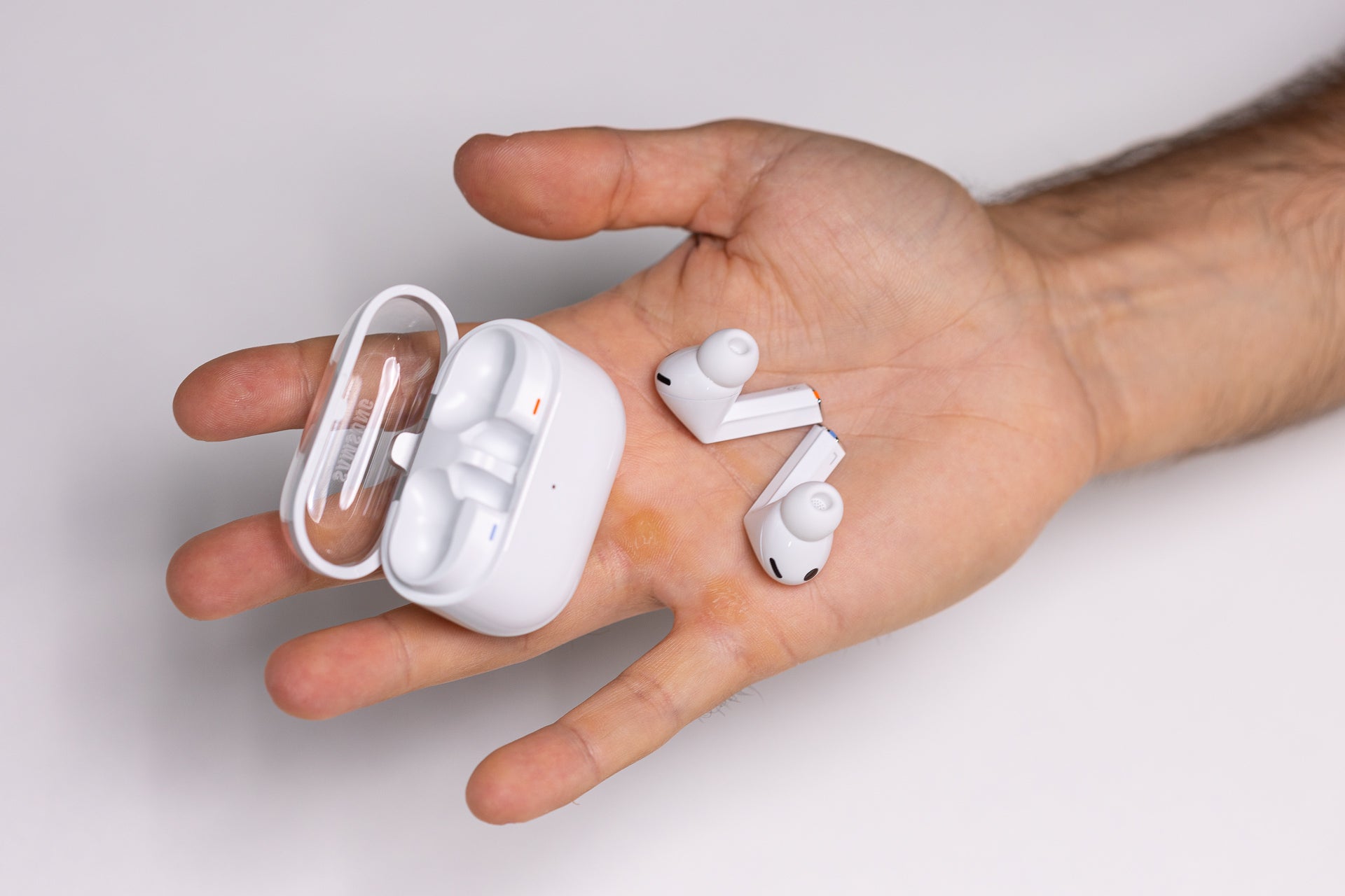 Galaxy Buds 3 Pro, placed in a person&amp;#039;s palm outside their charging case.