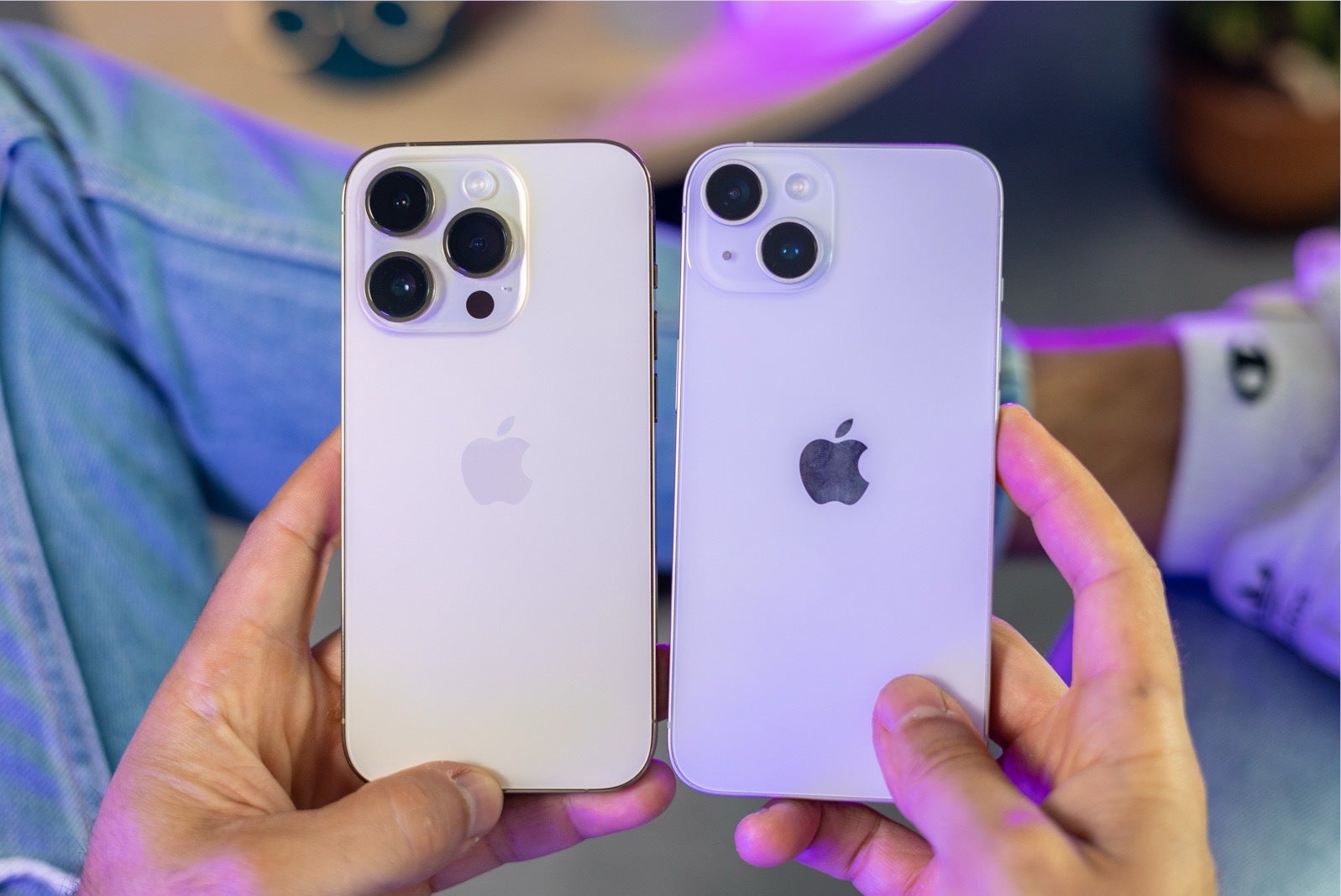 Image of an iPhone 14 Pro and iPhone 14 held up side by side