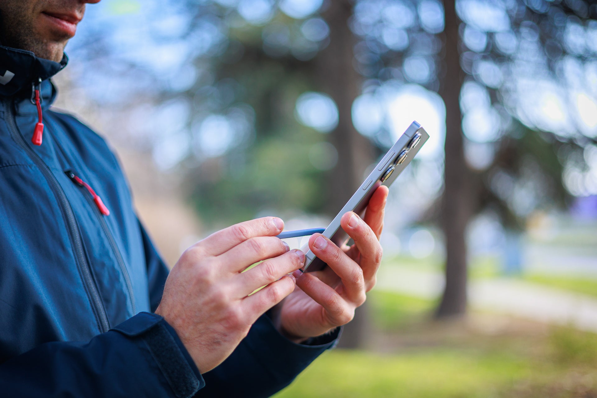 Man using phone with a stylus.