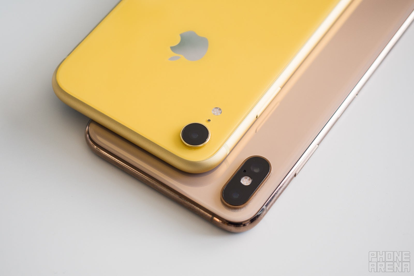 iPhone XR laying on top of iPhone XS Max, closeup of where their cameras intersect.