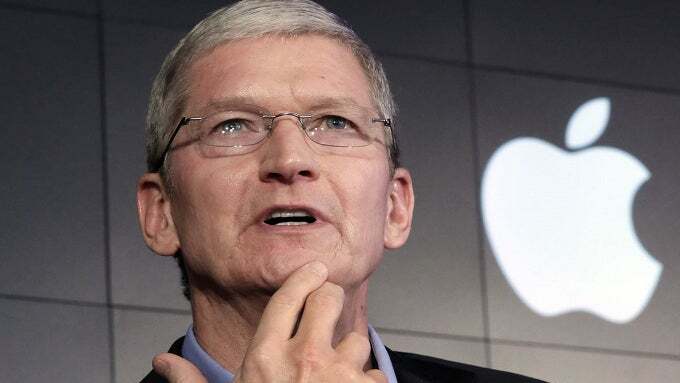 Apple CEO Tim Cook in a pensive moment with the Apple logo behind him