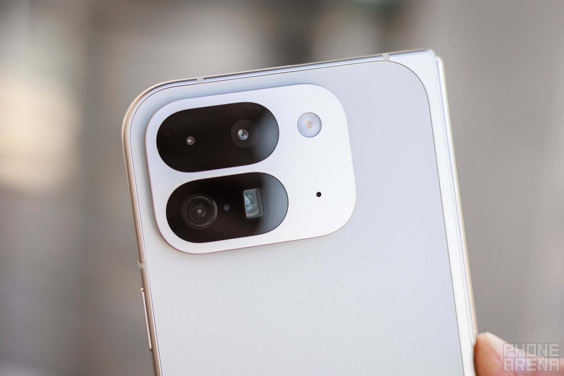 A photo of Pixel 9 Pro Fold in white, showing its back camera setup. 