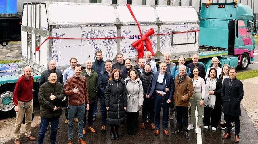 ASML employees stand in front of a box containing an unassembled High-NA EUV lithography machine before it was shipped to Intel. | Image credit-ASML - Seeking to regain process leadership from TSMC, Intel refused to make the same mistake twice