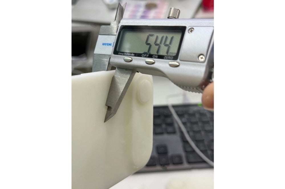 Image of an iPhone 17 Air dummy unit being measured