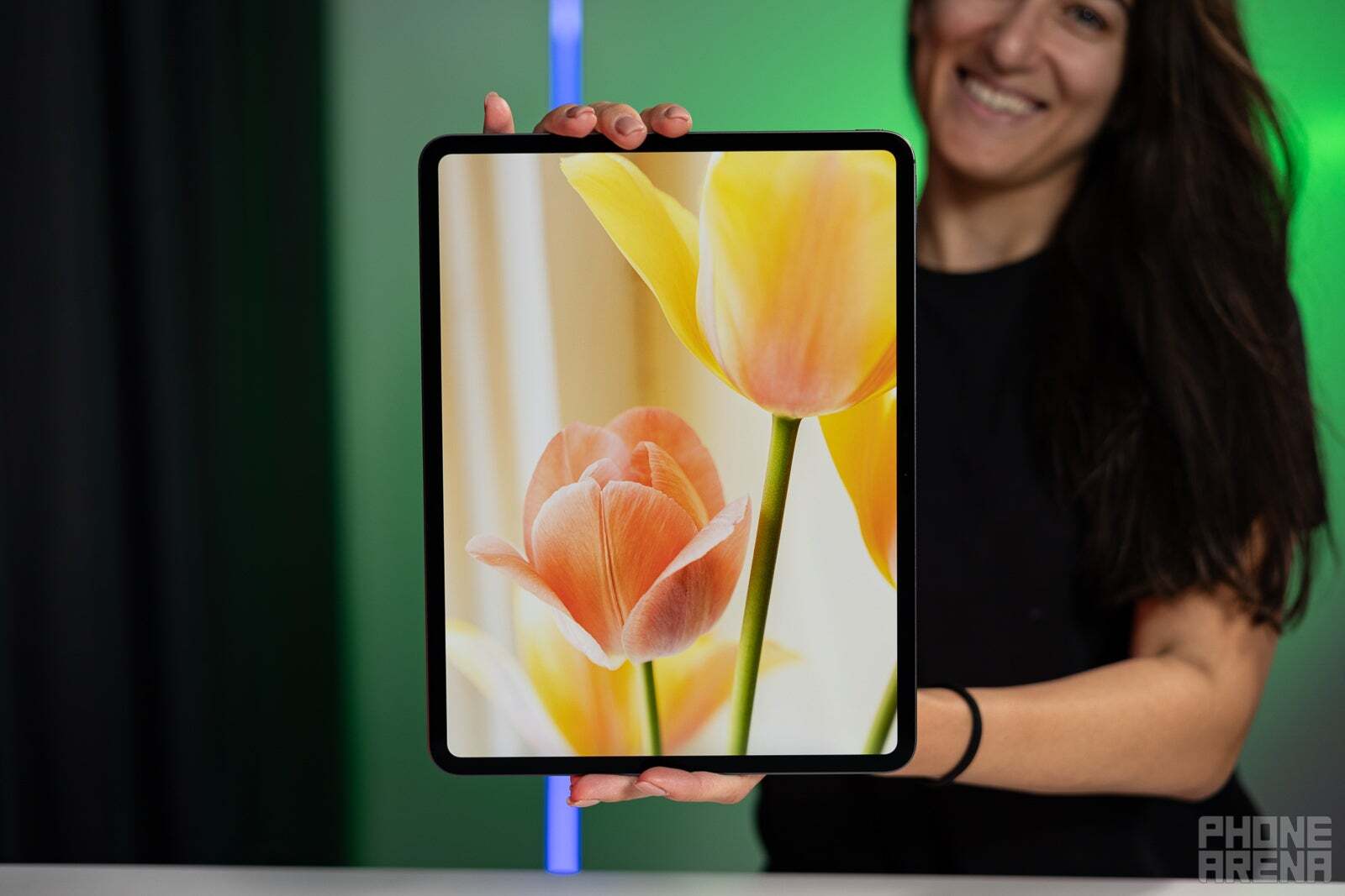 A woman holding an iPad Pro M4 with both hands.