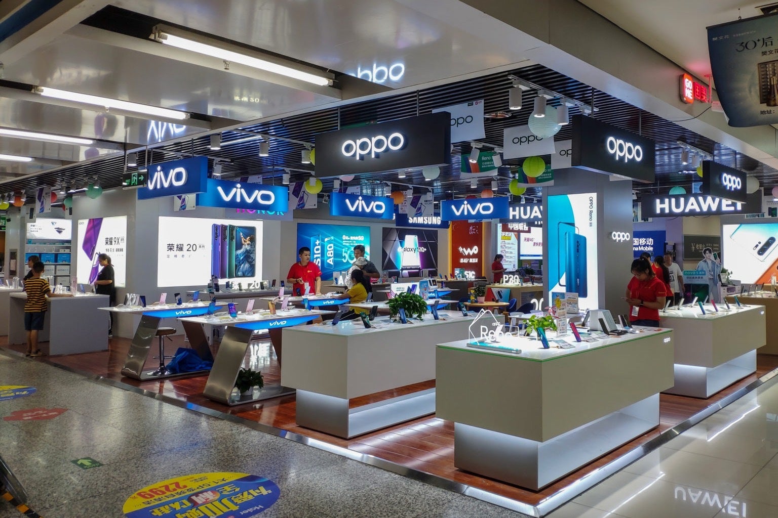 Image of several Chinese smartphone brand storefronts in a Chinese mall