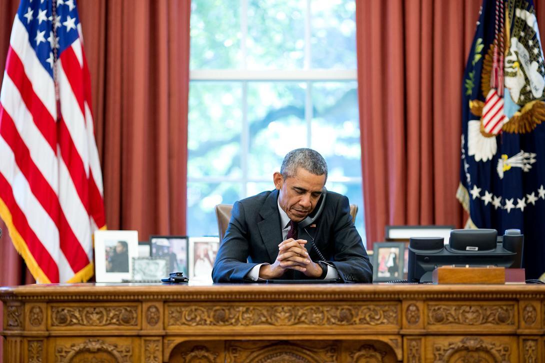 President Barack Obama working inside the Oval Office in the White House.