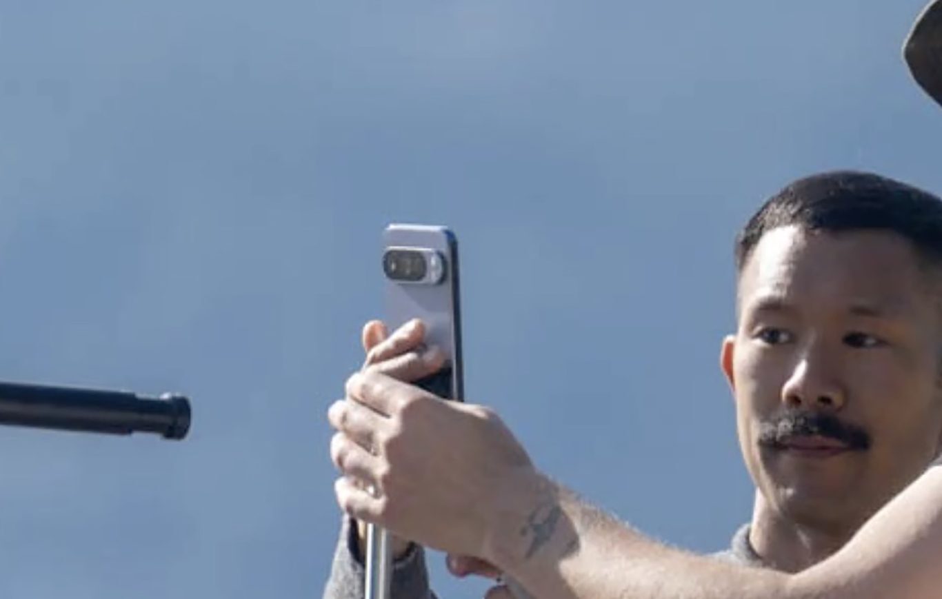 Crew member from the ad shoot holds a Pixel 10 Pro.