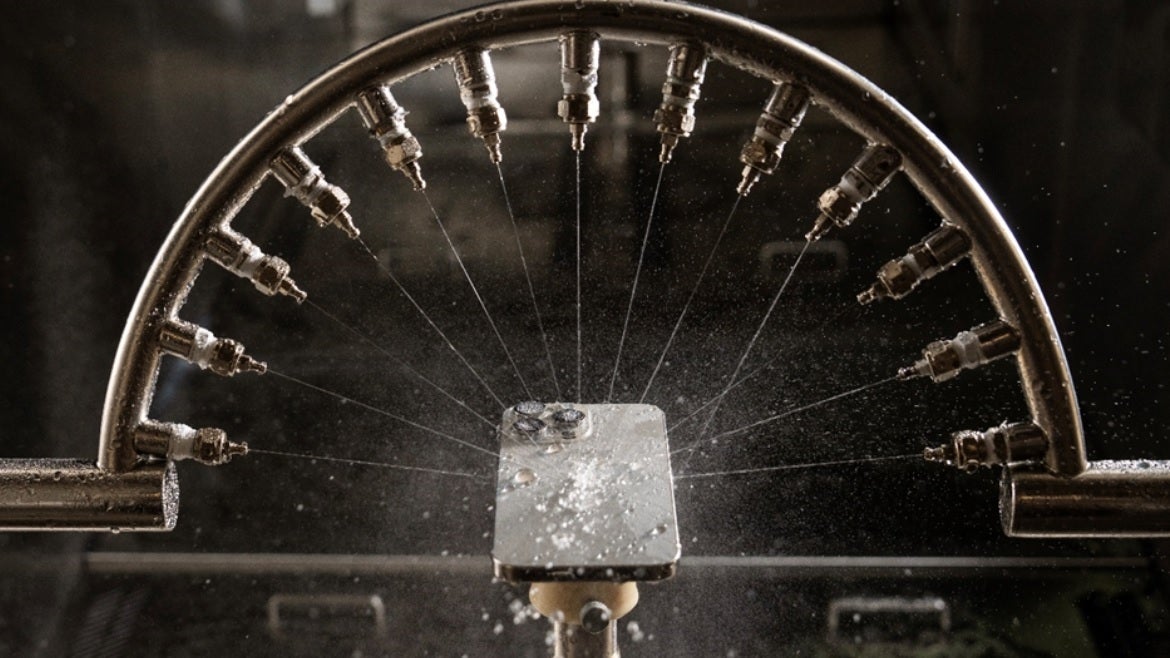 An iPhone is tested for resistance from the rain.