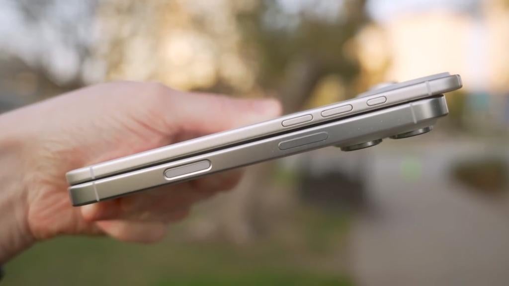 A photo of a person holding the iPhone 17 Air and iPhone 17 Pro in their hand.