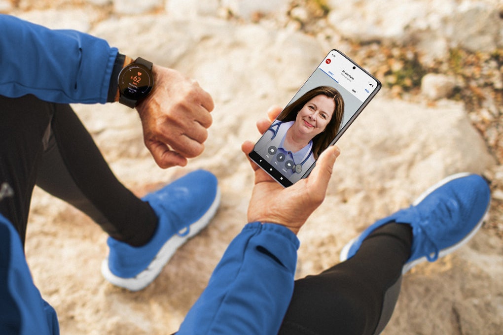 Image of person looking at smartphone with medical professional on a video call