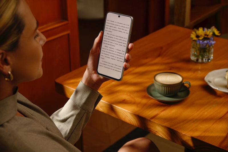 Person reading under soft light with the TCL Nxtpaper 60 Ultra