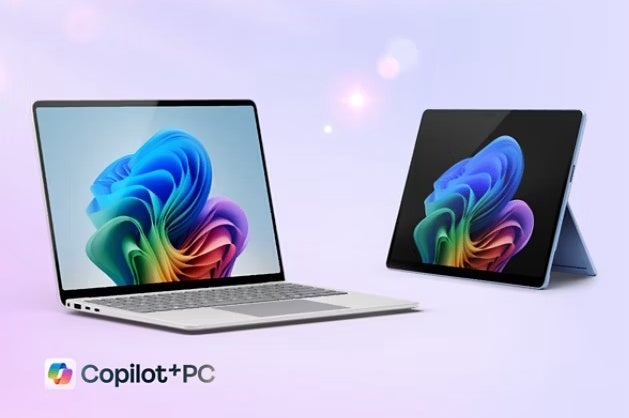 Two Microsoft Surface laptops advertising the use of Copilot