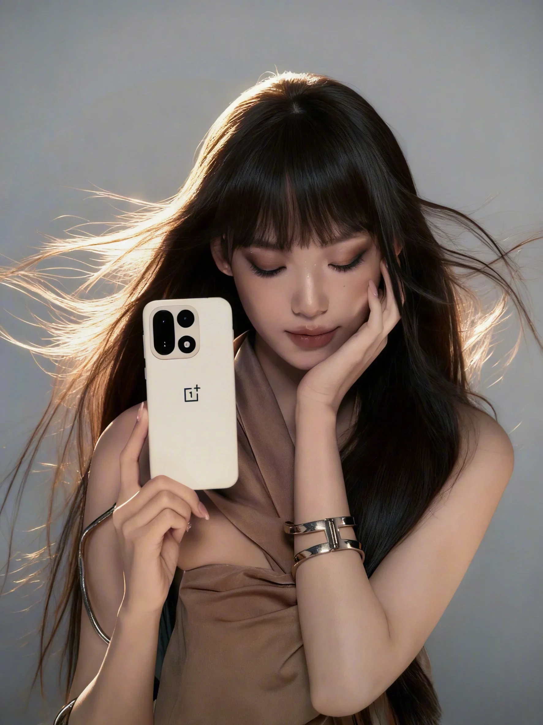 A model holding the OnePlus 15 next to her.