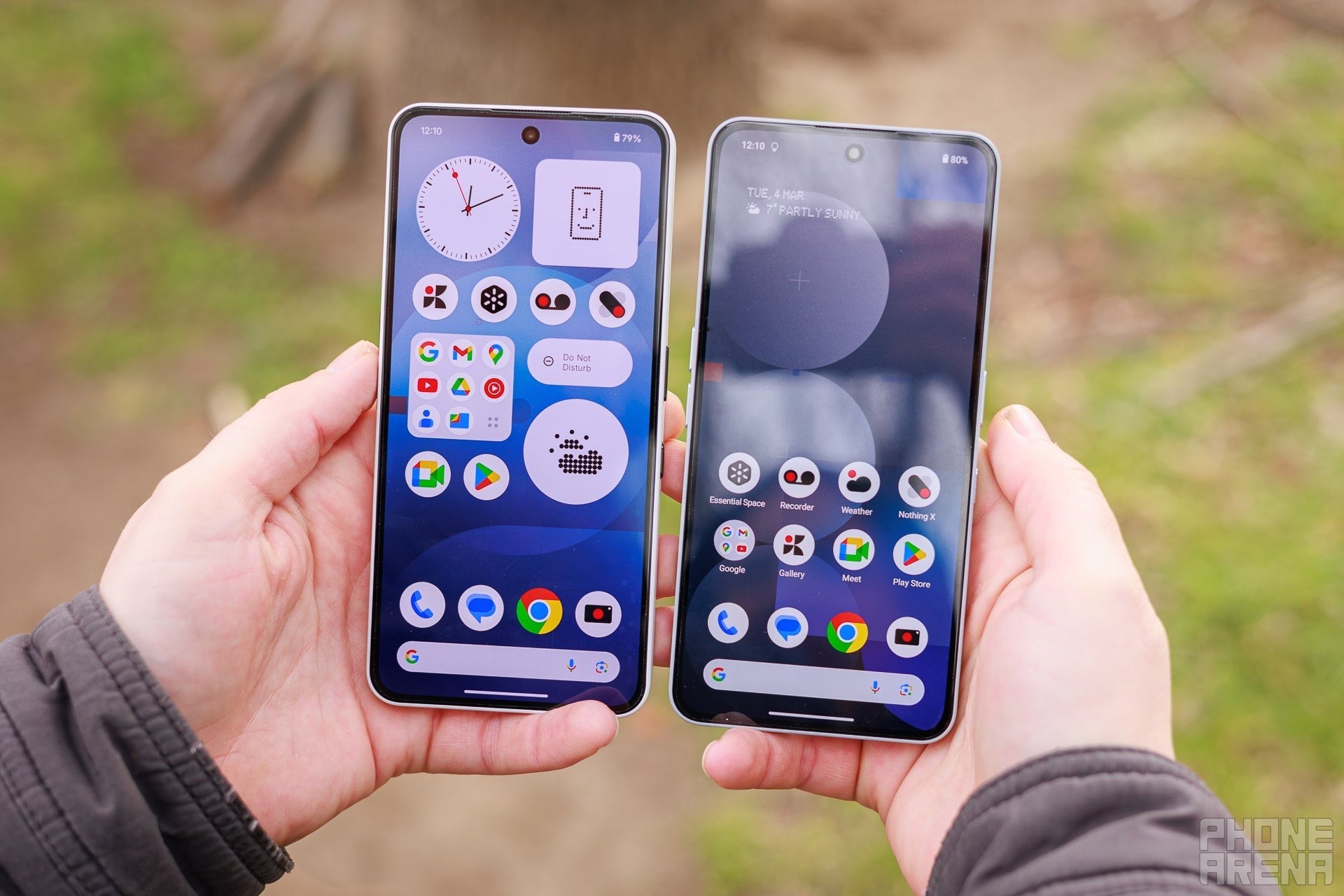 Two smartphones held side by side outdoors showing their home screens.