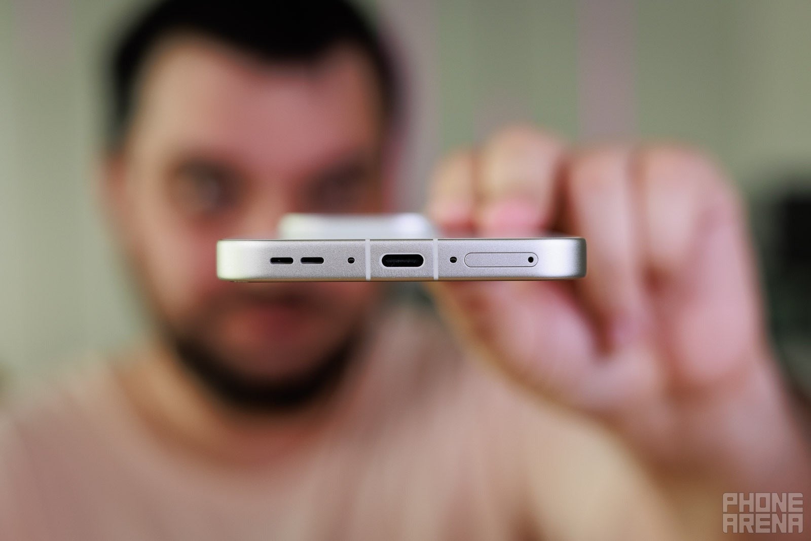 Close-up of a smartphone’s bottom edge showing USB-C port and speaker grilles.