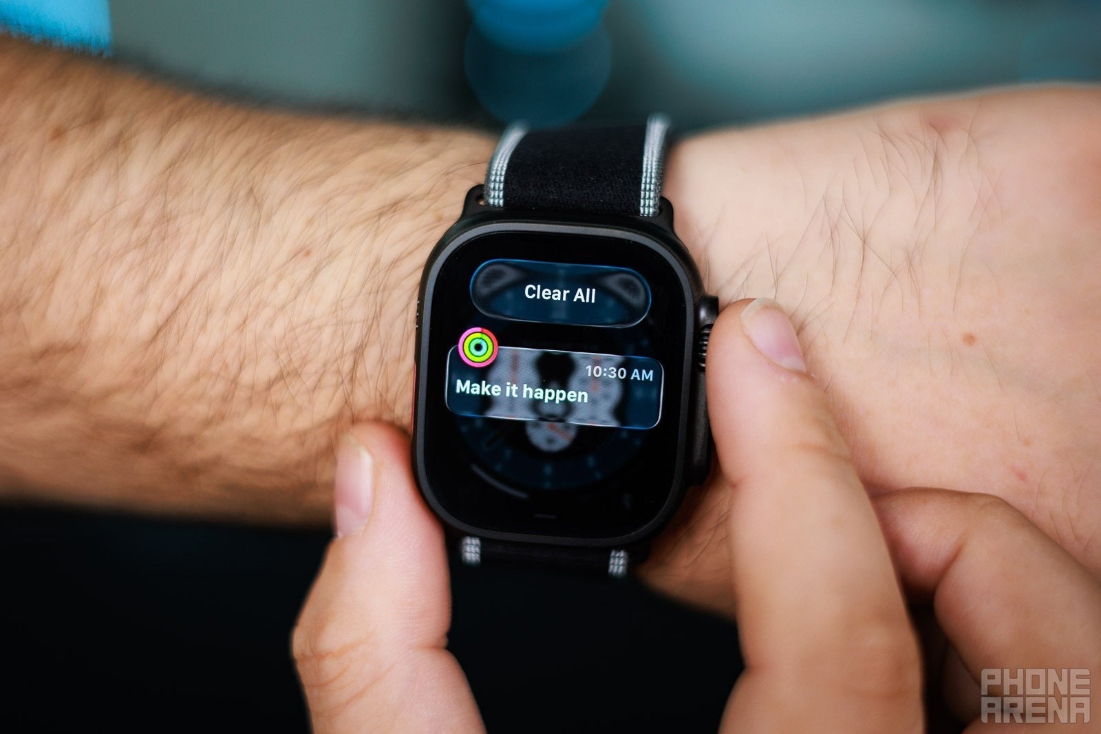Close-up of an Apple Watch displaying a fitness reminder notification.