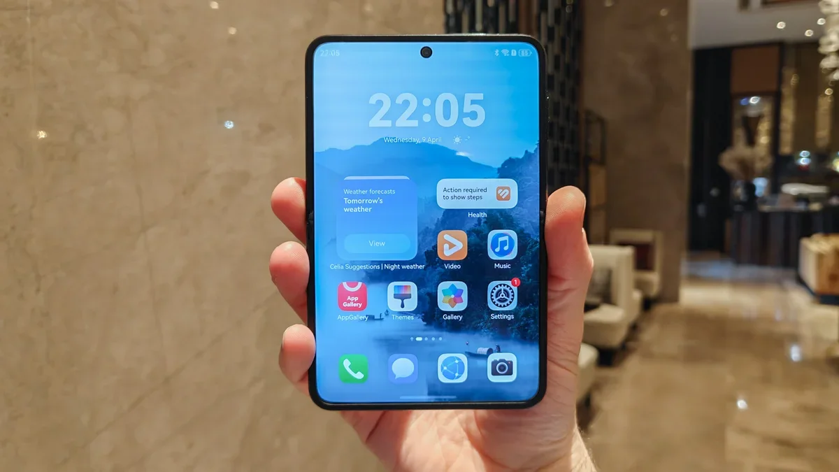 Huawei foldable phone held in hand.