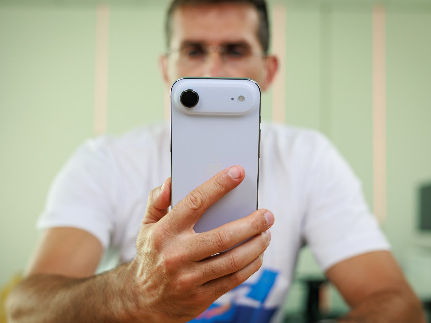 Holding up a white iPhone Air