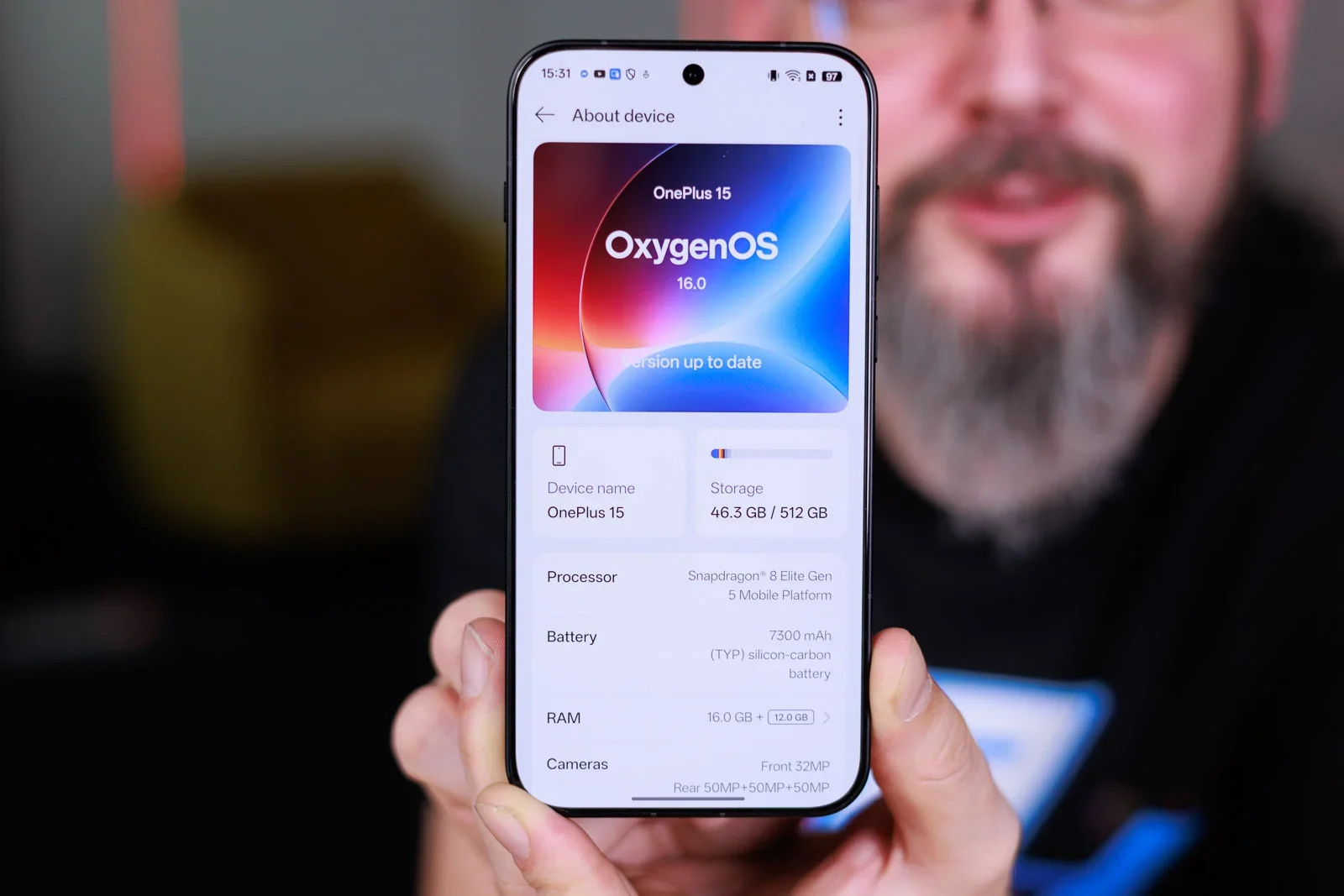 A man holding a OnePlus phone.