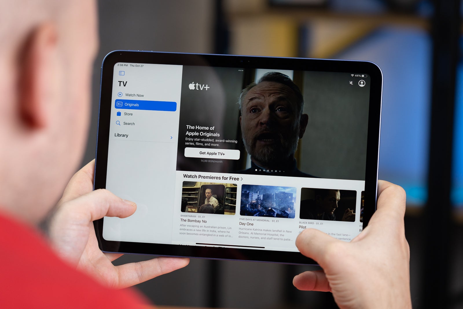 A man watching using the Apple TV+ app on his tab.