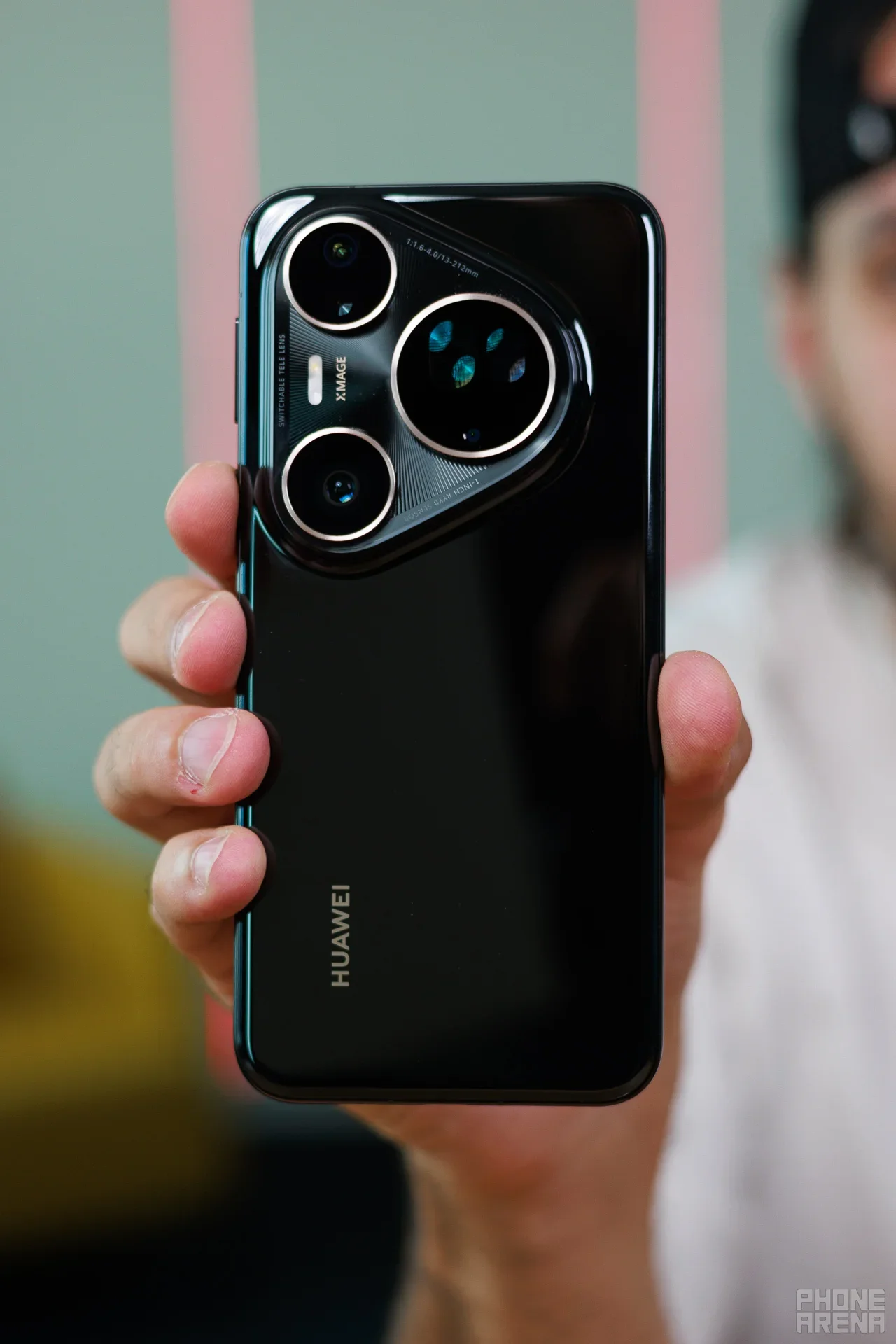 Huawei phone held in hand.