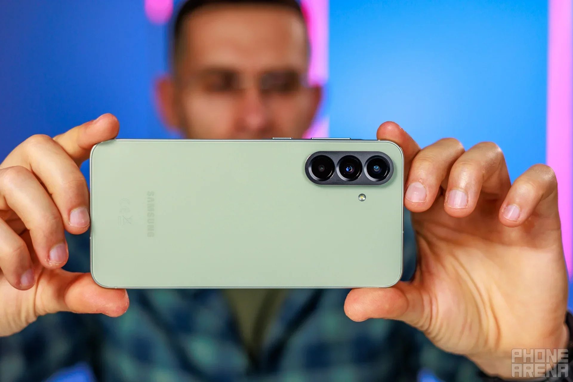 Galaxy phone held in hand.