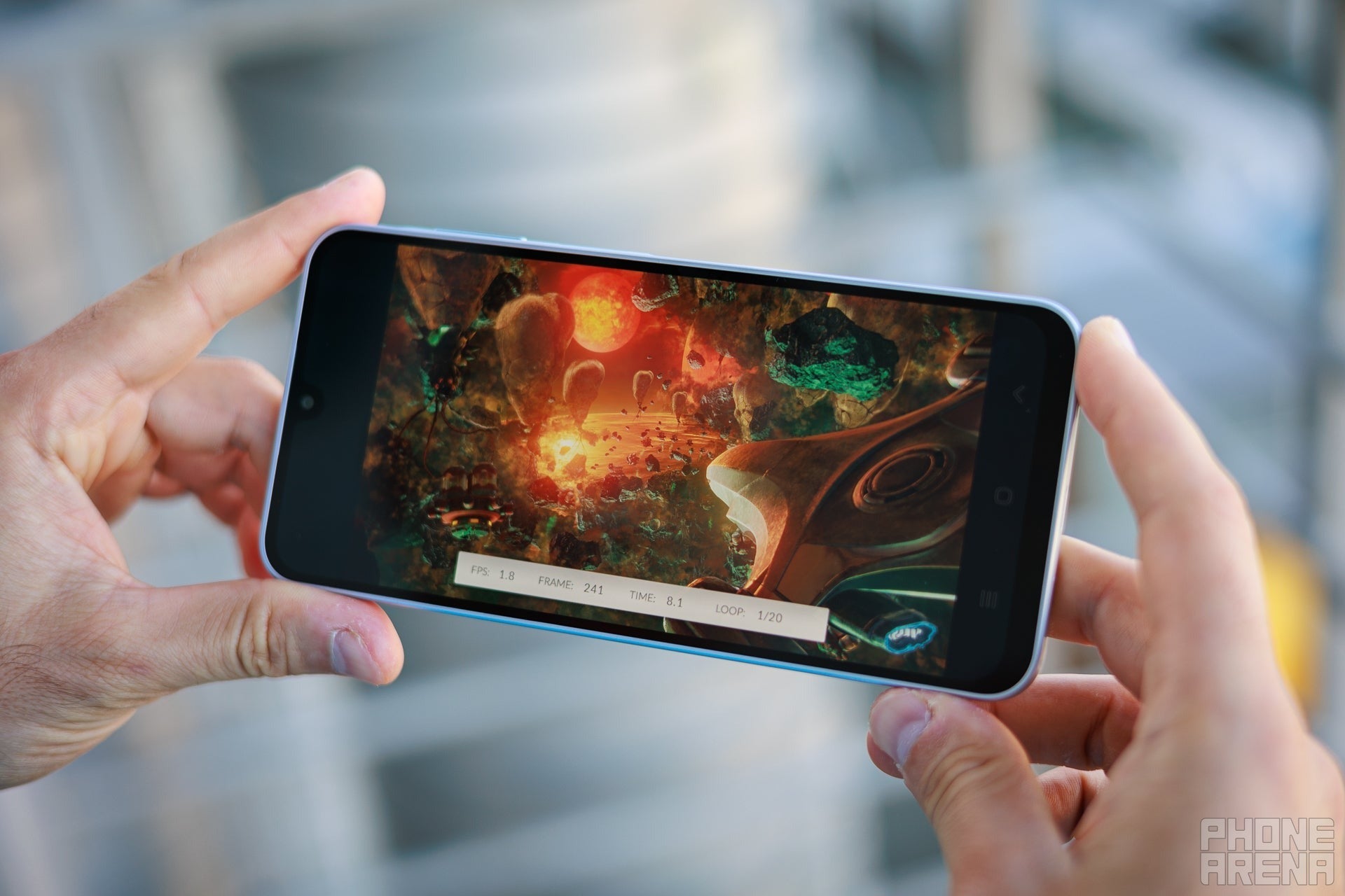 Person gaming on a phone held in landscape.