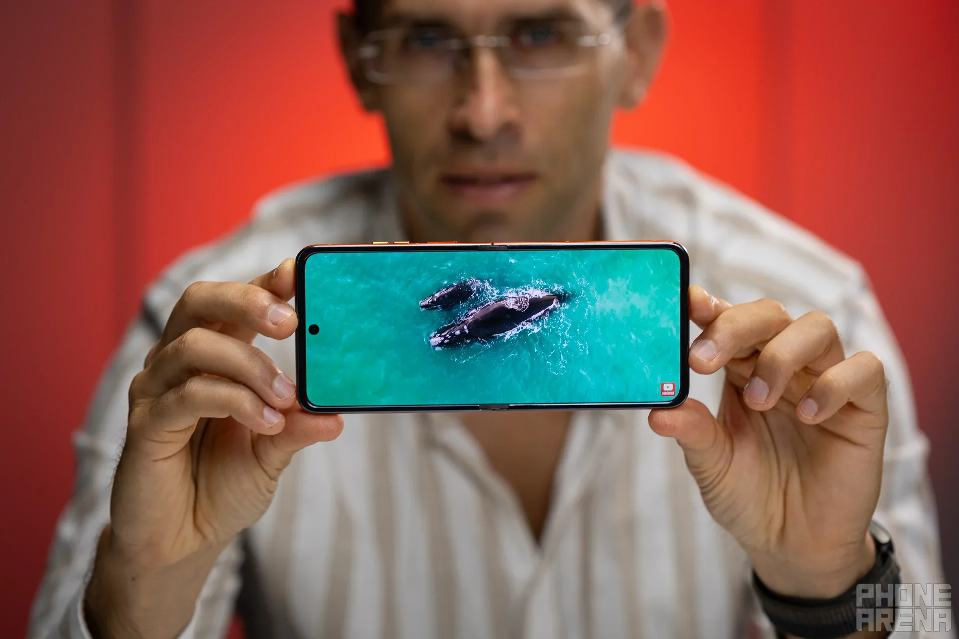 A photo of a person holding the Motorola Razr (2024). 