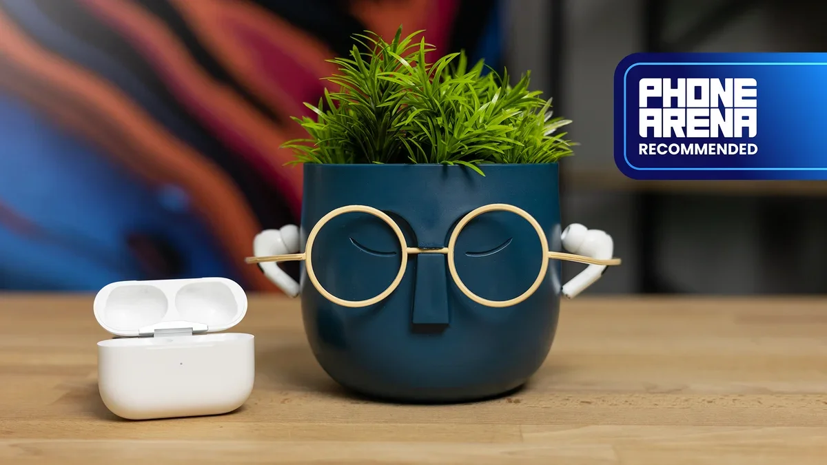 Apple AirPods Pro 2 earbuds resting on a decorative, face-shaped flower pot with a white charging case open beside it.