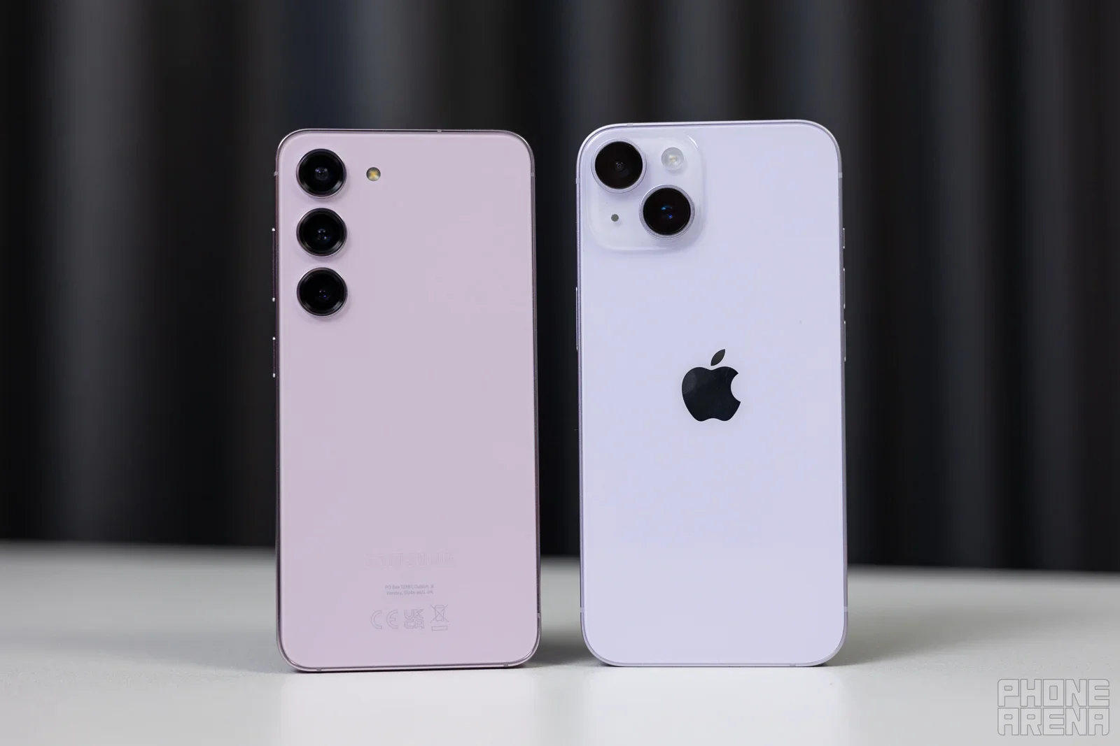 Galaxy phone and an iPhone on a desk.