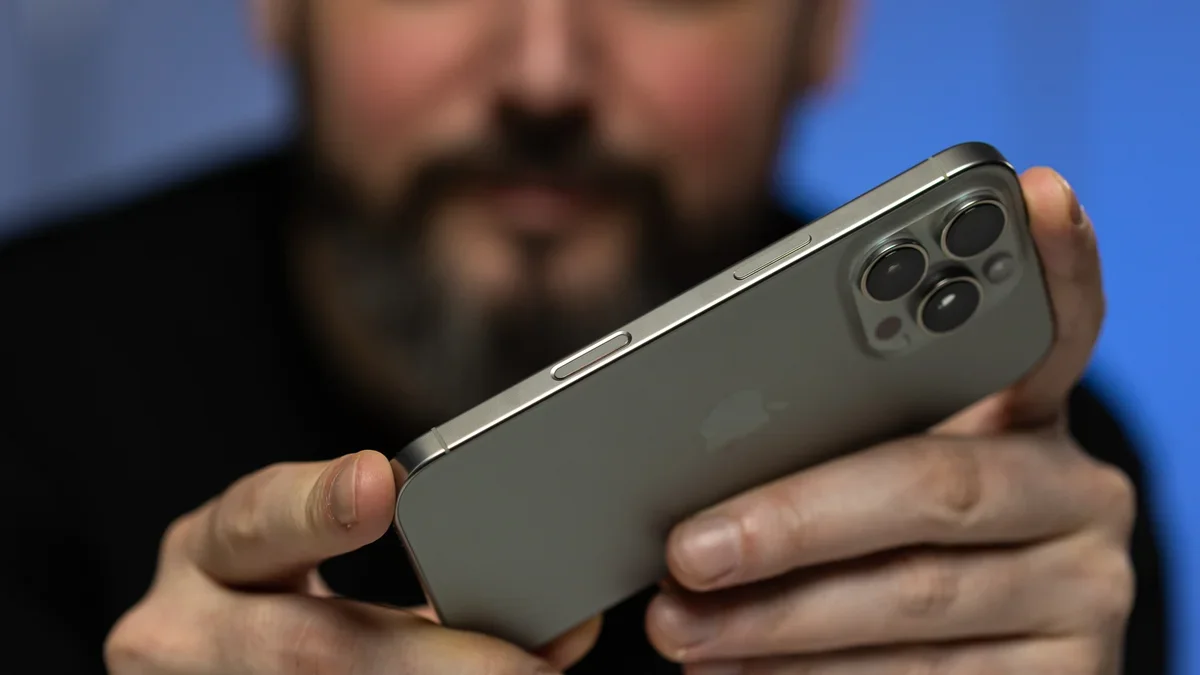 A close-up of a person holding the iPhone 16 Pro.