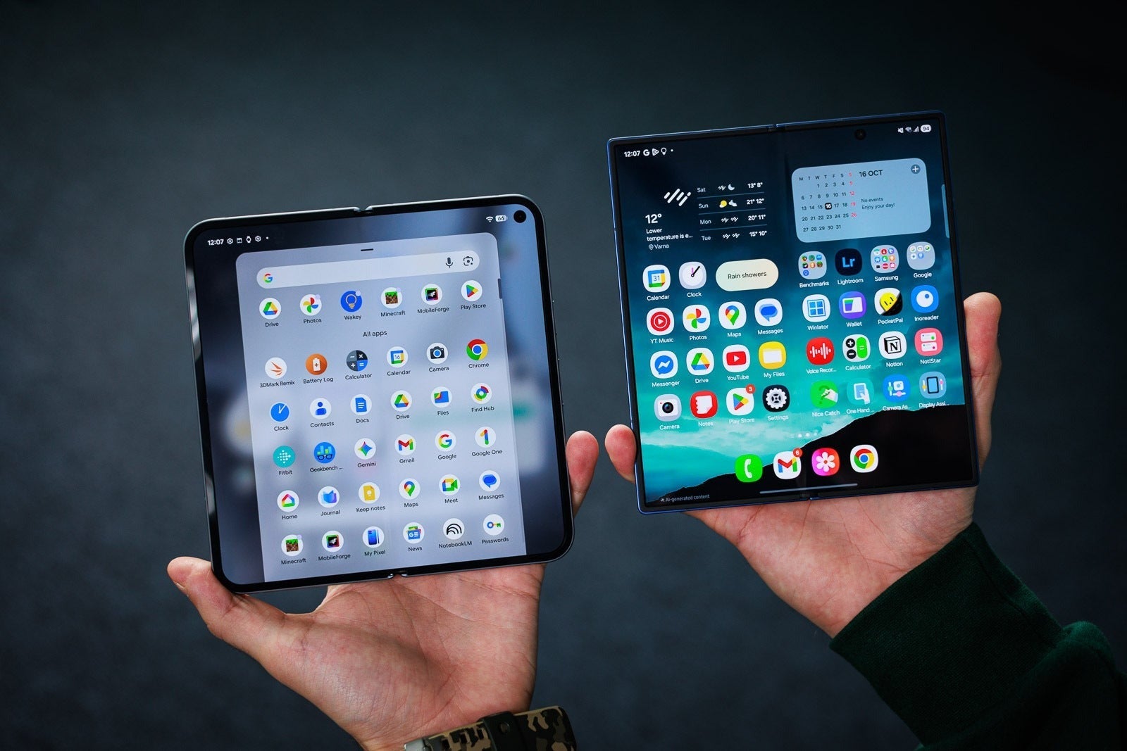 Two unfolded Android foldable phones held side by side, showing their app grids.