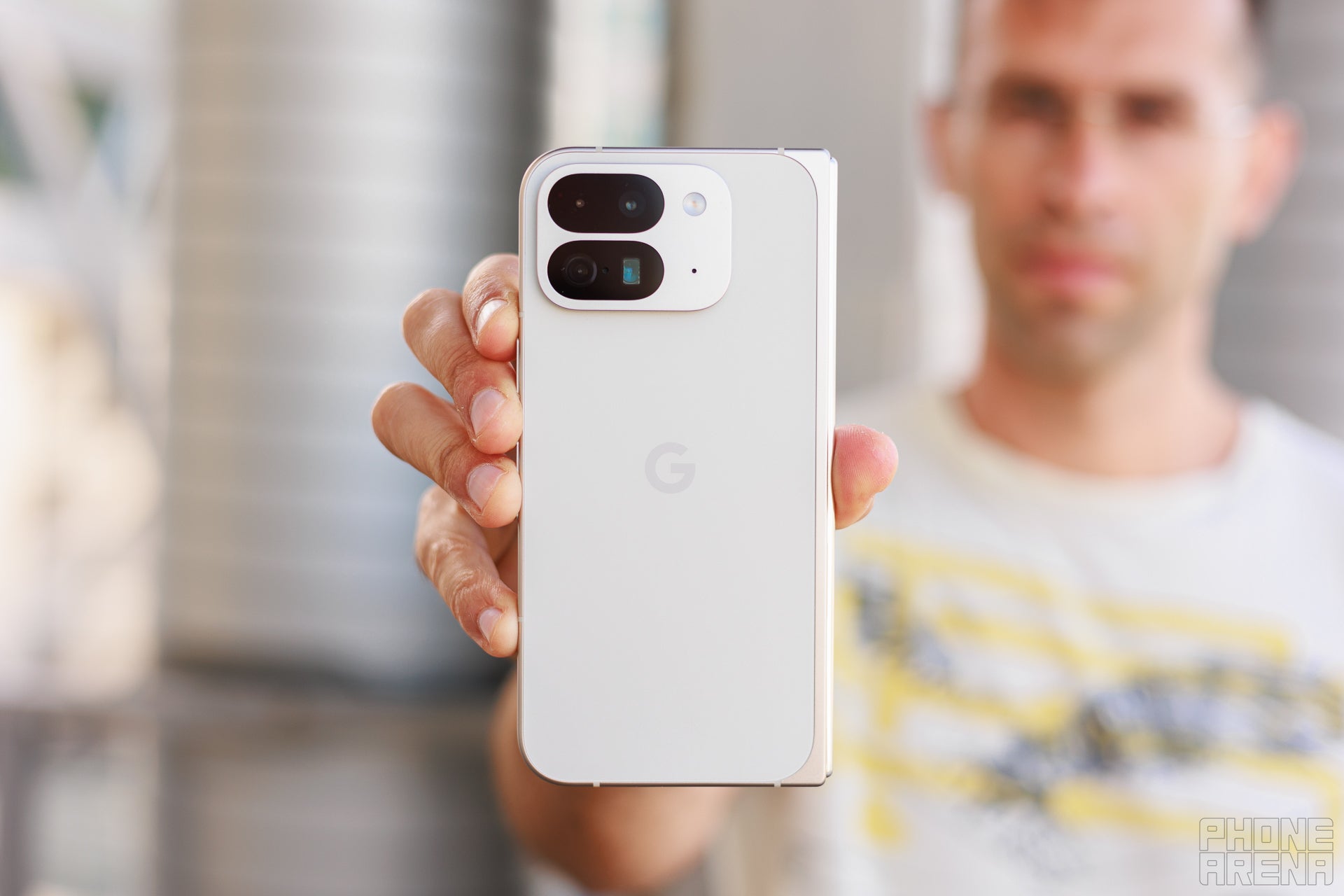 A man holding the Pixel 9 Pro Fold in his right hand.