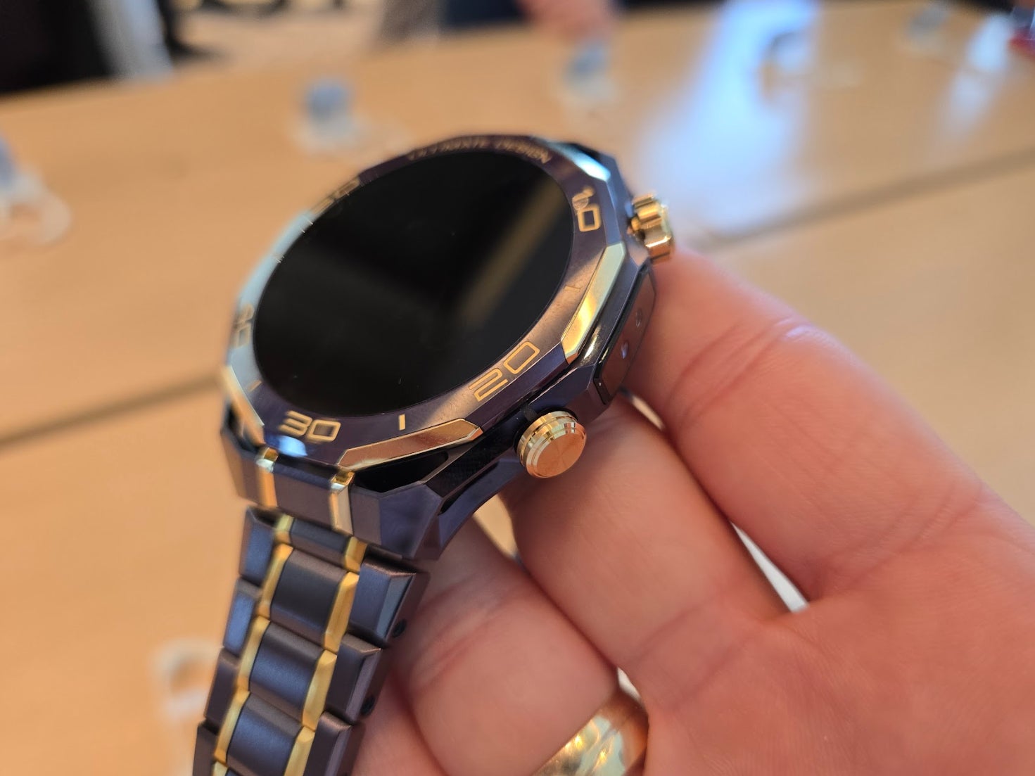 Holding the Huawei Watch Ultimate Design Royal Gold edition