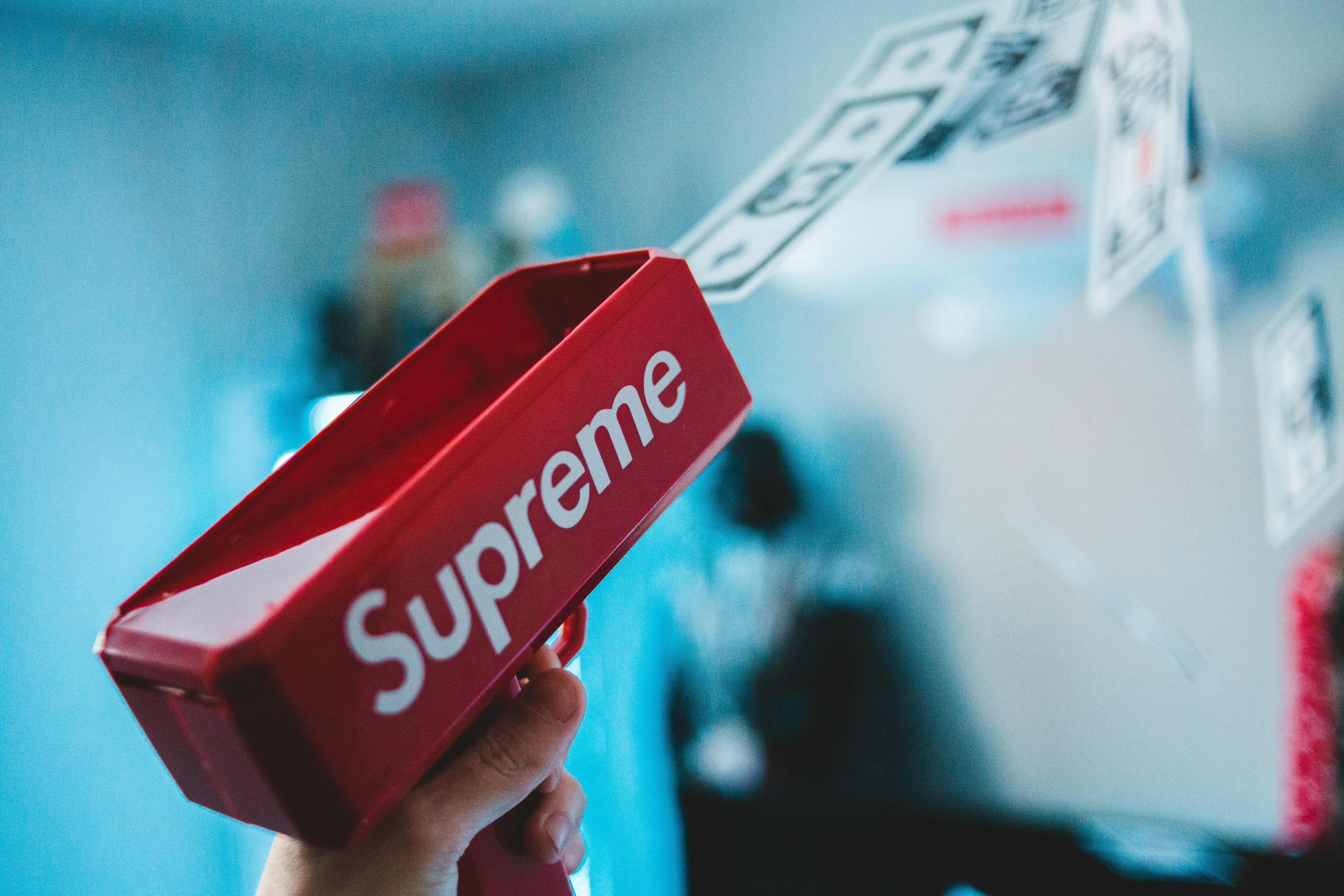Red Supreme money gun shooting fake bills