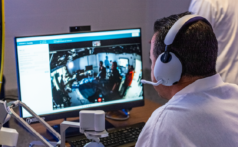 A doctor looking at a screen.