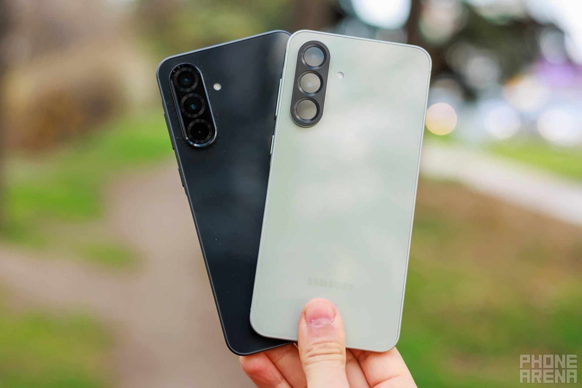 Two Samsung Galaxy A phones shown from the back outdoors