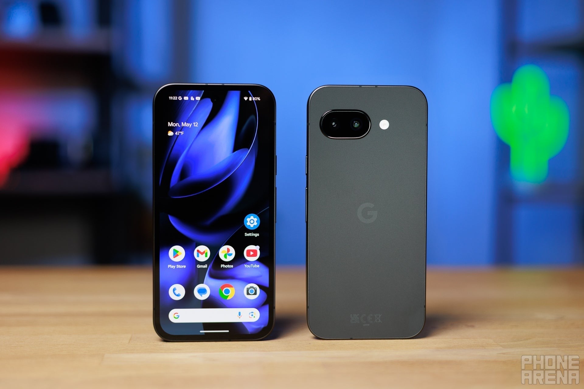 Front and back views of a Google Pixel phone standing on a table, showing the display and rear camera bar.